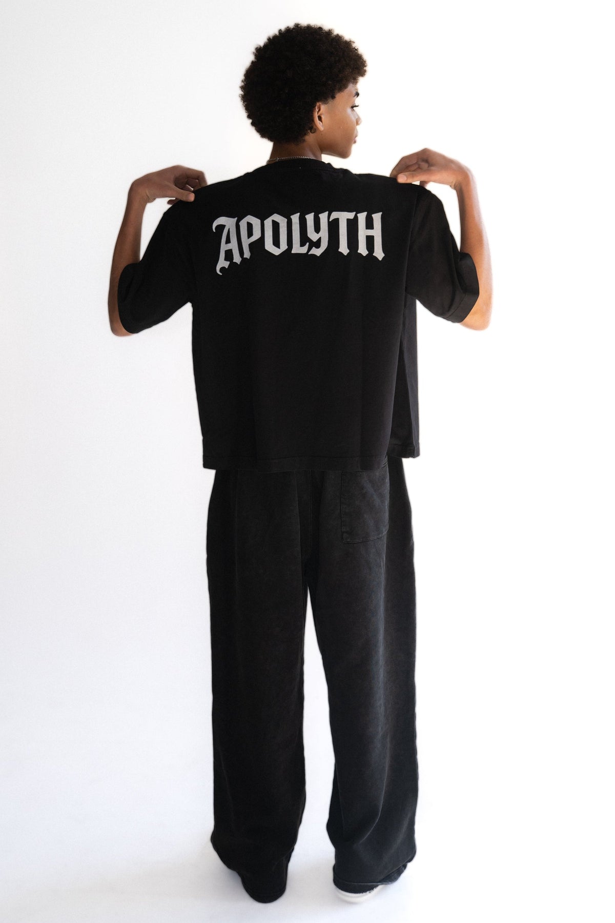Saints Dark Tunic in black cotton jersey, close-up.